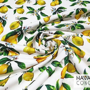 May include: White fabric with a repeating pattern of yellow lemons and green leaves. The fabric has the text "HAVANA CONCEPT" printed in the bottom right corner.