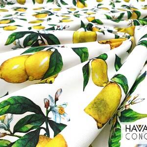 May include: White fabric with a repeating pattern of yellow lemons and green leaves. The fabric has the text "HAVANA CONCEPT" printed in black at the bottom right corner.