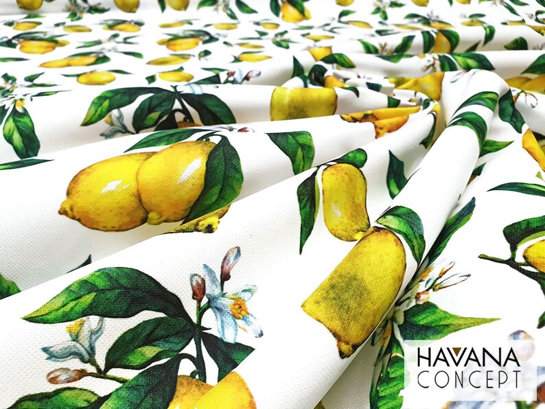 May include: White fabric with a repeating pattern of yellow lemons and green leaves. The fabric has the text "HAVANA CONCEPT" printed in black at the bottom right corner.
