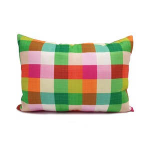 May include: A colorful pillow with a checkered pattern in shades of green, orange, pink, and red.
