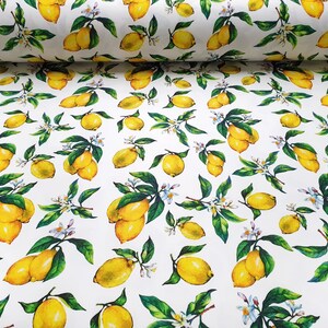 May include: White fabric with a repeating pattern of yellow lemons and green leaves. The lemons are drawn in a watercolor style.