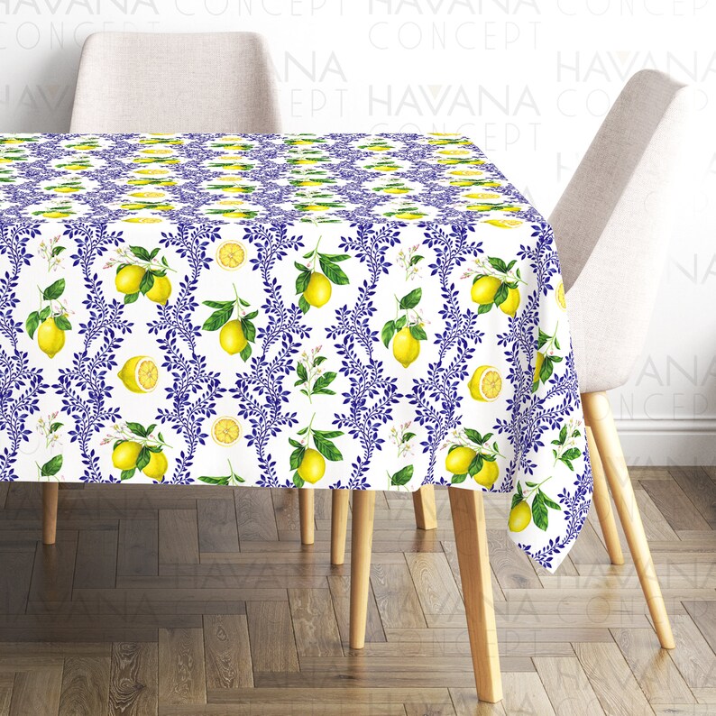 May include: White tablecloth with a blue and yellow lemon pattern. The tablecloth is on a wooden table with two chairs.