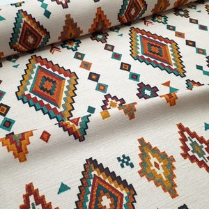 May include: White fabric with a repeating geometric pattern in shades of orange, red, teal, and brown. The pattern features diamond shapes with intricate details.