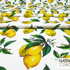May include: White fabric with a repeating pattern of yellow lemons and green leaves. The fabric has the text "HAVANA CONCEPT" printed in black at the bottom right corner.