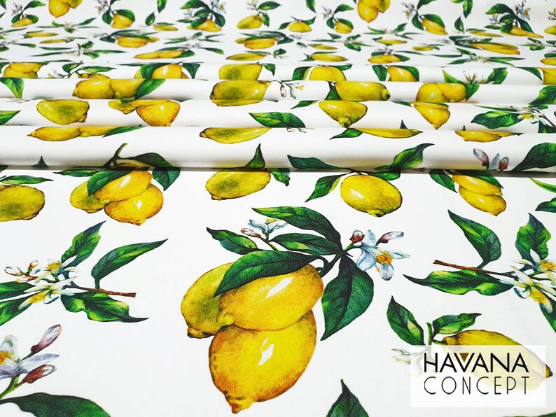 May include: White fabric with a repeating pattern of yellow lemons and green leaves. The fabric has the text "HAVANA CONCEPT" printed in black at the bottom right corner.