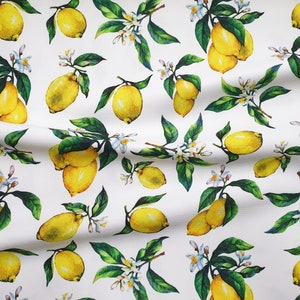 May include: White fabric with a repeating pattern of yellow lemons and green leaves. The lemons are drawn in a watercolor style and have a realistic appearance.