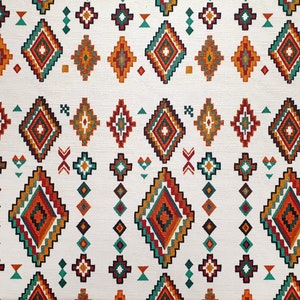 May include: White fabric with a repeating pattern of colourful geometric shapes. The pattern features a variety of diamond shapes in shades of orange, red, green, and blue. The background is white.