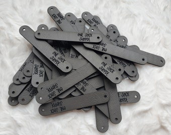 NEW Rivet style vegan leather tags .6 x 3.5" - RIVET not included- hole 3mm- text parallel to tag-priced for one side only - cost effective