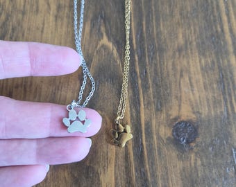 Mirror polished Stainless Steel petite paw print - plain or engraved with an initial - Gold or Silver - honour a beloved pet gift idea