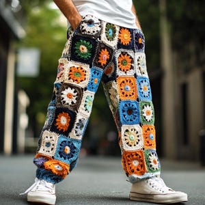 May include: A pair of colourful crocheted trousers with a patchwork design featuring squares of different colours and floral patterns. The trousers are made of a soft, textured yarn and have a relaxed fit.