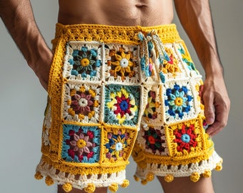 May include: Colourful crocheted shorts with a geometric pattern in shades of yellow, red, blue, green, and white. The shorts have a drawstring waist and a pom-pom trim.