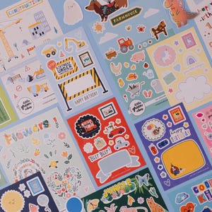 Sticker sheets featuring various children's themes, including construction, birthday, flowers, unicorns, jungle, and farm animals.