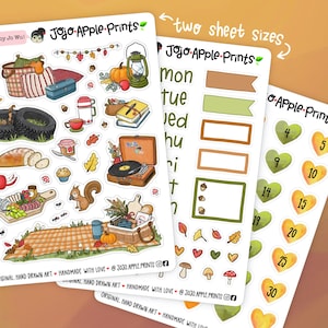 May include: Three sticker sheets by Jojo Apple Prints featuring autumn-themed illustrations including a picnic basket, record player, squirrel, pumpkins, calendar days, and heart-shaped numbers. The sheets include various fall icons and labels.