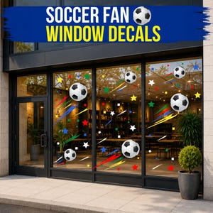 May include: Soccer fan window decals featuring black and white soccer balls, colorful stars, and motion streaks applied to a glass storefront. The text SOCCER FAN WINDOW DECALS is displayed in white and yellow on a blue banner at the top.
