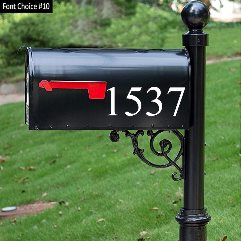 May include: Black mailbox with a white number 1537 on the front. The mailbox has a red flag.