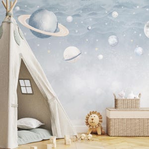May include: A child's room with a space-themed mural featuring planets and stars. A beige teepee tent with a small window is on the left. A lion stuffed animal and a woven basket with toys are on the right.