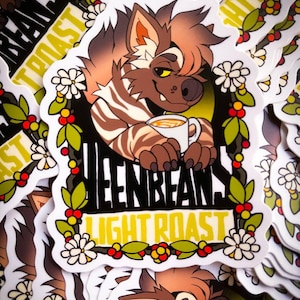 May include: A sticker featuring a cartoon wolf-like creature holding a cup of coffee. The sticker has a yellow and green floral border with the text "Greenbeans Light Roast".