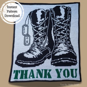 May include: A crochet pattern for a square blanket featuring a pair of black and white military boots with dog tags and the words "THANK YOU" in green.