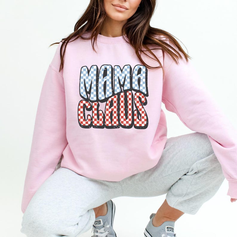 May include: Pink sweatshirt with a red and blue chequered graphic that says "Mama Claus".