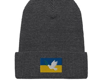 100% van de winst naar Oekraïne – vlag UA met vredesduif, beanie met wafelpatroon – opbrengst komt ten goede aan Oekraïners, details in beschrijving