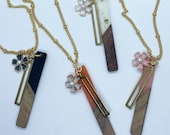 Wood and epoxy necklace, brass bar charm, brass and acrylic flower charm with perl accent