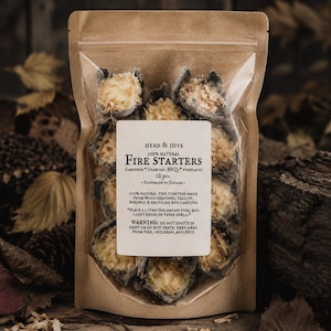 May include: A clear plastic and brown paper pouch containing 12 Herd & Hive 100% natural fire starters. The label lists ingredients including wood shavings, tallow, beeswax, and recycled egg cartons, with instructions and safety warnings included.