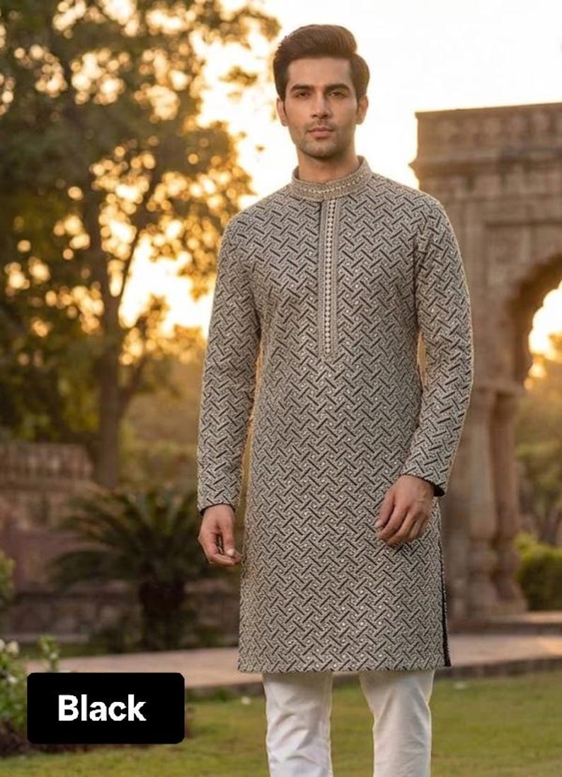 May include: A long-sleeved, patterned tunic in shades of gray and black, paired with white pants. The tunic features a mandarin collar and a vertical zipper. The word "Black" is displayed in a black box at the bottom.