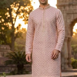 May include: A light pink long-sleeved kurta with a geometric pattern and a mandarin collar. The kurta is paired with white pants. The word "Pink" is in a box in the lower left corner.