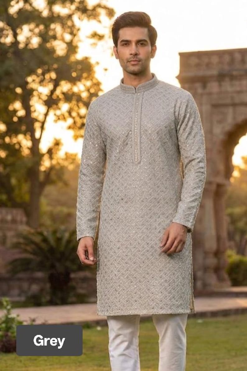 May include: A light grey kurta with a geometric pattern and long sleeves. The kurta has a mandarin collar and is paired with white pants. The outfit is suitable for formal occasions.