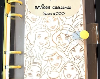May include: Clear binder with yellow accents and a cover featuring Disney princess illustrations. The cover text reads "Monthly Princess Savings Challenge" and "Saves $6,000". The binder is designed for financial planning and organization.