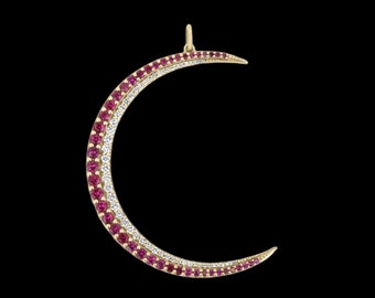 May include: A gold crescent moon pendant with a double row of gemstones. The top row is set with pink gemstones and the bottom row is set with clear gemstones.