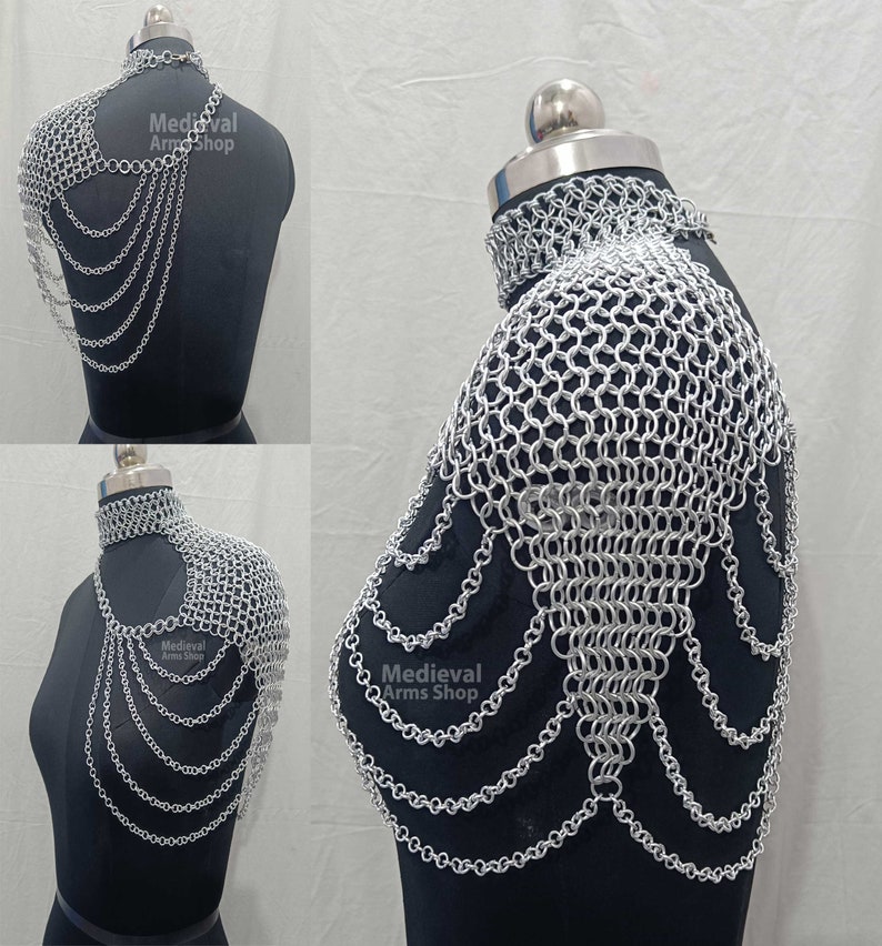May include: Silver chainmail shoulder armor with a decorative chainmail collar. The armor is made of interlocking metal rings and has a flowing, cascading design. The text "Medieval Arms Shop" is visible on the armor.