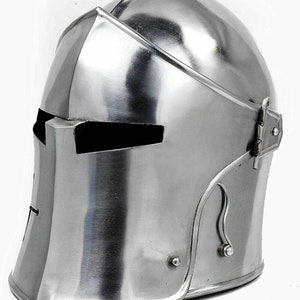 May include: A silver helmet with a visor and a hinged cheek guard. The helmet is made of metal and has a smooth, polished finish.