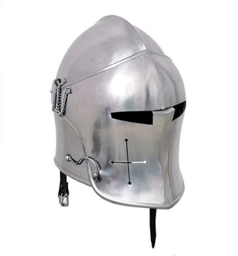 May include: A silver helmet with a visor and a cross on the front. The helmet has a pointed chin guard and a strap that goes under the chin.