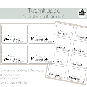Op de afbeelding: Printbare cadeau-etiketten met de tekst "eine Kleinigkeit für dich" (een klein cadeautje voor jou) in zwarte tekst op een witte achtergrond. De etiketten zijn ontworpen voor gebruik op cadeauzakken.