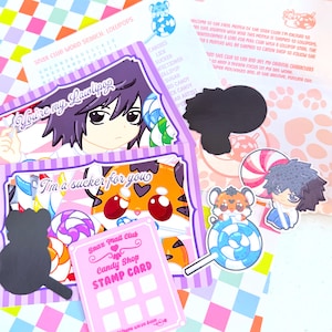May include: A collection of stationery items including a Snax Club word search, a Snax Mail Club candy shop stamp card, and several stickers featuring anime-style characters, a tiger, and colorful lollipops with text like You're my Lawlipop.
