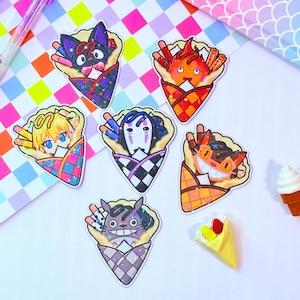 May include: Five colorful stickers featuring characters from the animated film 'Spirited Away' in a crepe cone. The characters are No Face, Jiji, Chihiro, Haku, and Totoro. Each sticker has a holographic finish.