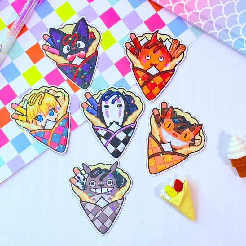 May include: Five colorful stickers featuring characters from the animated film 'Spirited Away' in a crepe cone. The characters are No Face, Jiji, Chihiro, Haku, and Totoro. Each sticker has a holographic finish.