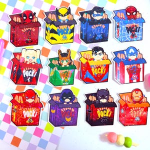 May include: A collection of colorful stickers featuring various comic book characters popping out of Pocky boxes. Each box is a different color and design, with the Pocky logo visible. Characters include Deadpool, Wolverine, and Spider-Man.