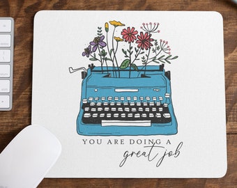 May include: A blue typewriter with a bouquet of flowers in the carriage. The typewriter has a white background with the text "You are doing a great job".