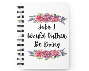 May include: White spiral-bound notebook with the text "Jobs I Would Rather Be Doing" in black script. The text is framed by watercolor floral arrangements in shades of pink, purple, and green.