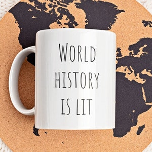 May include: White ceramic mug with a black outline and the text "WORLD HISTORY IS LIT" on a cork coaster with a black world map.
