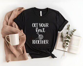 May include: Black t-shirt with white text that reads "Get your knit together" and a graphic of a ball of yarn and knitting needles.