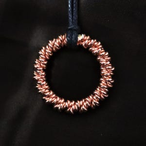 Anello tensore in rame: ciondolo a tripla torsione New Dimension - Cubito perduto 177Mhz