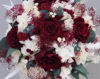 Bridal bouquet of dried flowers in wine red, cream and white with stabilized roses