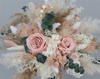 Bridal bouquet of dried flowers in pastel shades with stabilized roses