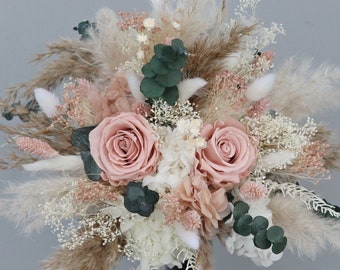 Bridal bouquet of dried flowers in pastel tones with stabilized roses