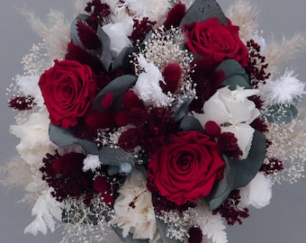 Bridal bouquet of dried flowers in burgundy, cream and white with preserved roses