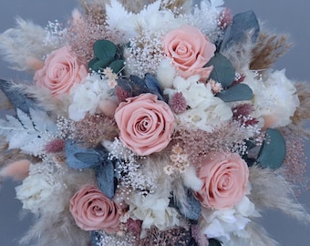 Bridal bouquet made of dried flowers in pastel shades with preserved roses