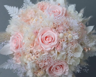 Dreamlike bridal bouquet of dried flowers in pastel shades with stabilized roses